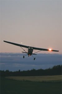 Single-engine aircraft flying at evening time