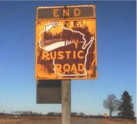 Weathered and faded Rustic Road sign