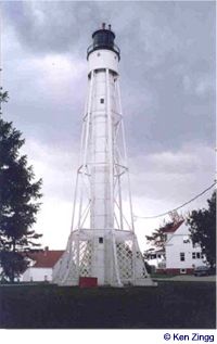 The lighthouse beacon stands tall against a looming sky