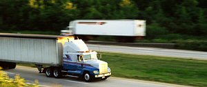 Semi-trucks with trailers traveling a highway