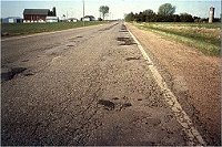 Badly deteriorated roadway.
